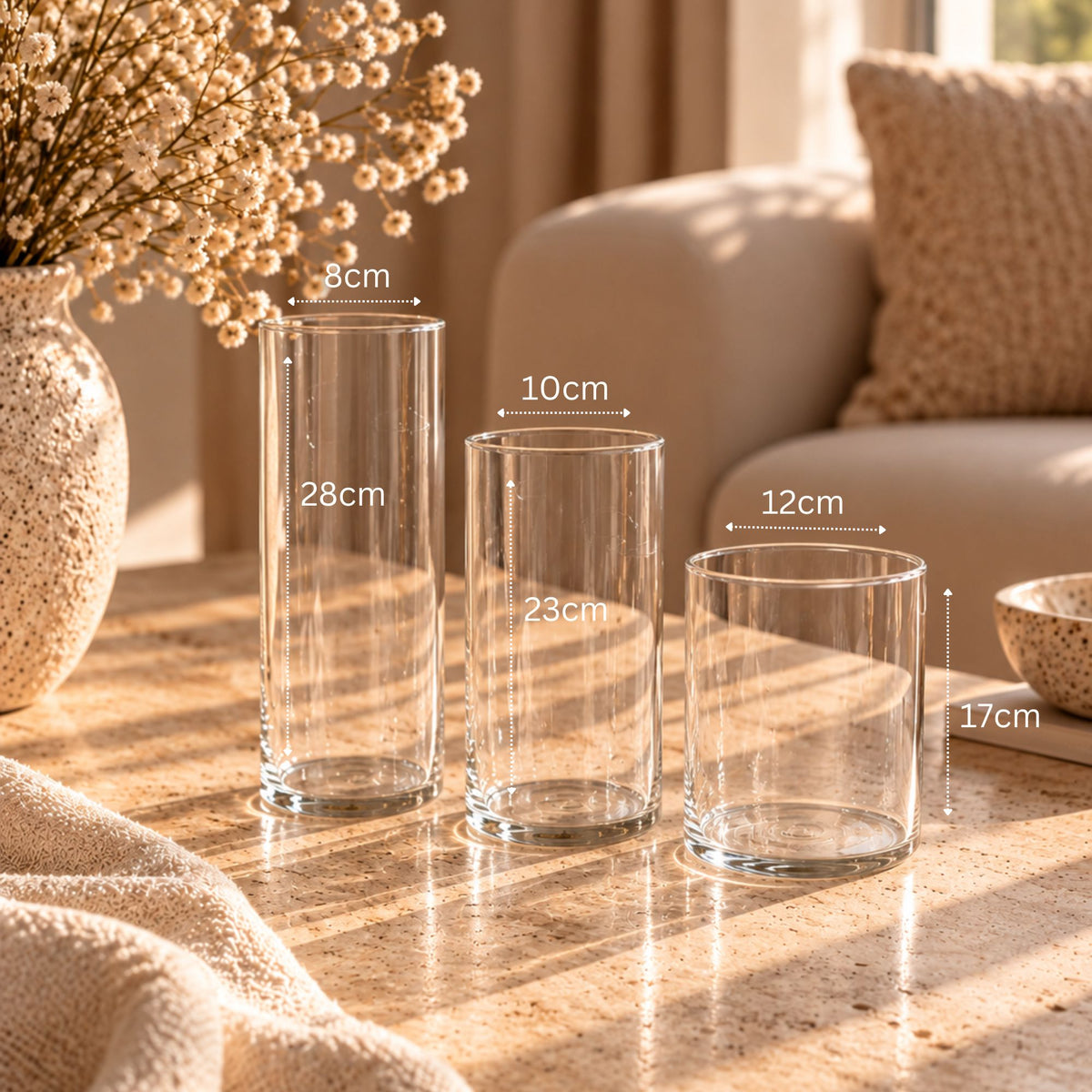 Clear glass cylinder vase set of 3 showing dimensions of 8 x 28 cm, 10 x 23 cm and 12 x 17 cm